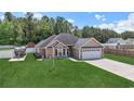 Spacious single Gathering home with a large, well-manicured lawn and attached two-car garage at 210 Fox Hunt Pl., Aynor, SC 29511