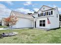 Charming two-story home with an American flag, dark shutters and a well-manicured lawn at 2858 Ellesmere Circle, Myrtle Beach, SC 29579