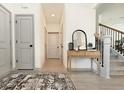 Inviting hallway features hardwood floors, grey doors, console table with mirror and stairs at 2858 Ellesmere Circle, Myrtle Beach, SC 29579