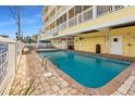 A well-maintained in-ground outdoor pool is surrounded by brick pavers and patio furniture at 301 N Waccamaw Dr. # 110, Murrells Inlet, SC 29576