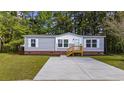 Charming single-story home with vinyl siding, brick foundation, and a concrete driveway at 3175 Lyndon Dr., Little River, SC 29566