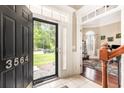 Inviting foyer with tiled flooring, a visible living room, and an exterior view through the front door at 3564 Brampton Dr., Myrtle Beach, SC 29588