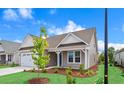 Well-maintained home showcasing manicured lawn, complemented by the charming exterior paint scheme at 367 Broughton Dr., Myrtle Beach, SC 29579