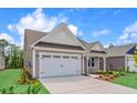 Beautiful home with a two-car garage, complemented by professional landscaping and a concrete driveway at 367 Broughton Dr., Myrtle Beach, SC 29579