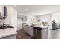 Open-concept kitchen featuring granite countertops and stainless steel appliances at 399 Acosta Circle, Conway, SC 29527