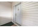 Close-up of a white front door with a decorative welcome sign and white siding at 4429 Turtle Ln. # 3A, Little River, SC 29566