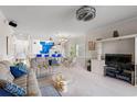 Open-concept living room with plush sofa, dining area, and bright kitchen in the background at 4429 Turtle Ln. # 3A, Little River, SC 29566