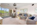 Cozy living room featuring neutral carpeting, comfortable seating, and a sliding glass door to the outside at 4429 Turtle Ln. # 3A, Little River, SC 29566