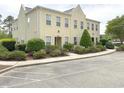 Neutral townhome featuring lush landscaping and ample parking spaces at 4532 Girvan Dr. # A, Myrtle Beach, SC 29579