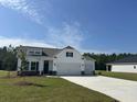 Beautiful two-story home with a two-car garage, a well-manicured lawn, and ample parking at 4750 N Huckleberry Ln., Conway, SC 29526