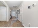 Bright hallway with wood floors, white walls and doors, and smart home features at 520 Scarlet Sage Dr., Conway, SC 29527