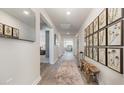 Bright hallway featuring wood floors, stylish decor, and neutral wall paint at 520 Scarlet Sage Dr., Conway, SC 29527