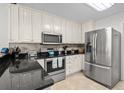 Modern kitchen featuring stainless steel appliances and white cabinetry at 527 Bay Drive Ext., Garden City Beach, SC 29576