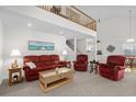 Inviting living room with vaulted ceilings, a cozy red sofa, and a view of the upper level at 527 Bay Drive Ext., Garden City Beach, SC 29576