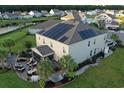 Aerial view featuring a spacious home equipped with solar panels, screened in porch, and an outdoor seating area at 5809 Oakbury Ct., Myrtle Beach, SC 29579