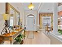 Inviting entryway with wooden floors, console table and arched doorway to other rooms in home at 5916 Falcon Landing Circle, North Myrtle Beach, SC 29582