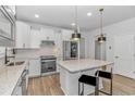 Bright kitchen featuring white cabinets, stainless steel appliances, and a granite island at 6076 Campanella St., Myrtle Beach, SC 29577