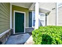 Welcoming front door entrance with manicured bushes and a cozy, covered porch at 6172 Catalina Dr. # 214, North Myrtle Beach, SC 29582