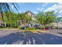 A multi-level condo building surrounded by trees and green shrubs at 683 Riverwalk Dr. # 302, Myrtle Beach, SC 29579