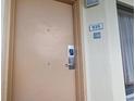 A nondescript door with a faded number 935 and a no-smoking sign on a textured wall at 6900 Ocean Blvd. # 935, Myrtle Beach, SC 29572