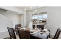 Elegant dining room with a dark wood table, seating for six, and a large window providing natural light at 733 Choctaw Dr., Conway, SC 29526