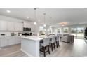 Modern kitchen features a large island with seating, stainless steel appliances, and an open view to the living room at 733 Choctaw Dr., Conway, SC 29526