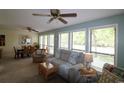 Comfortable living room featuring a sofa, chairs, ceiling fans, and large windows bringing in plenty of natural light at 861 Tall Oaks Ct. # D-61, Myrtle Beach, SC 29588