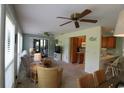 Open-concept living and kitchen area with comfortable seating, ceiling fans, and bar-style eating at 861 Tall Oaks Ct. # D-61, Myrtle Beach, SC 29588