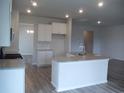 Bright kitchen featuring granite countertops, white cabinets and stainless steel faucet fixture at 8719 Baton Rouge Ave Nw, Calabash, NC 28467