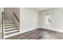 Bright entryway with staircase, door with sidelight, and wood-look flooring at 889 Ireland Dr., Longs, SC 29568