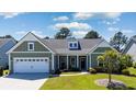 Charming single-story home featuring a manicured lawn, tidy landscaping, and a convenient two-car garage at 9169 Nw Oldfield Rd., Calabash, NC 28467