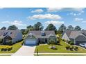 Inviting single-Gathering home with a manicured lawn, mature trees and an attached two-car garage at 9169 Nw Oldfield Rd., Calabash, NC 28467