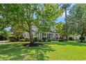 Charming two-story home with inviting front porch, columns and landscaped yard with mature trees at 93 Knotty Pine Way, Murrells Inlet, SC 29576