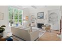 Bright living room featuring large windows, fireplace, and stylish decor at 93 Knotty Pine Way, Murrells Inlet, SC 29576