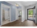 Open entryway showcasing a bathroom and bedroom with bright natural light and wood flooring at 100 Oak Leaf Dr., Longs, SC 29568