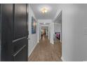 Hallway with wood floors with views to an open concept floor plan and neutral color palette at 100 Oak Leaf Dr., Longs, SC 29568