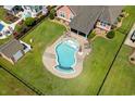 Aerial view of the backyard pool with a waterfall feature, shed, and patio area for entertaining at 1133 6Th Ave. S, North Myrtle Beach, SC 29582
