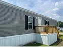 Exterior view of charming manufactured home with inviting wooden deck and stairs at 1242 Carrie Bell Ln, Myrtle Beach, SC 29577