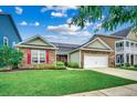 Inviting single-story home featuring stone facade, red shutters, and lush green lawn under a bright sky at 1286 Culbertson Ave., Myrtle Beach, SC 29577