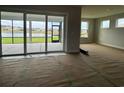 Bright living room with sliding glass doors leading to a screened porch and lake views at 1430 Crested Iris Way, North Myrtle Beach, SC 29582