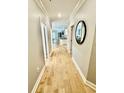 Bright hallway with light hardwood flooring and neutral walls leading to the main living areas at 144 Puffin Dr. # 1-A, Pawleys Island, SC 29585