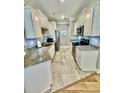 Well-lit kitchen featuring stainless steel appliances, granite countertops, and white cabinetry at 144 Puffin Dr. # 1-A, Pawleys Island, SC 29585