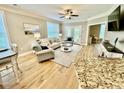 Cozy living room with comfortable seating, bright windows, and hardwood floors at 144 Puffin Dr. # 1-A, Pawleys Island, SC 29585