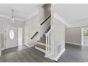 Bright foyer with stylish gray flooring, a staircase, and an open entryway at 1720 Horry St., Conway, SC 29526