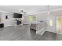 Cozy living room featuring a fireplace, gray flooring, and a ceiling fan at 1720 Horry St., Conway, SC 29526