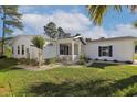 This white home features well-manicured landscaping, a charming front porch, and a well-maintained lawn at 1755 Fairbanks Dr., Conway, SC 29526