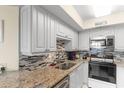 Well-equipped kitchen featuring white cabinets, mosaic backsplash, and stainless appliances at 201 S Ocean Blvd., North Myrtle Beach, SC 29582
