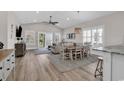Open-concept living room and dining area with wood floors and abundant natural light at 226 9Th Ave. S, North Myrtle Beach, SC 29582