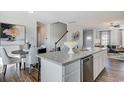 Bright kitchen boasts granite countertops, stainless steel appliances, and a view of the dining area at 246 Mayflower Dr., Calabash, NC 28467