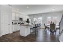Sunlit kitchen with granite counters, stainless appliances, large island, and open access to the dining area at 246 Mayflower Dr., Calabash, NC 28467